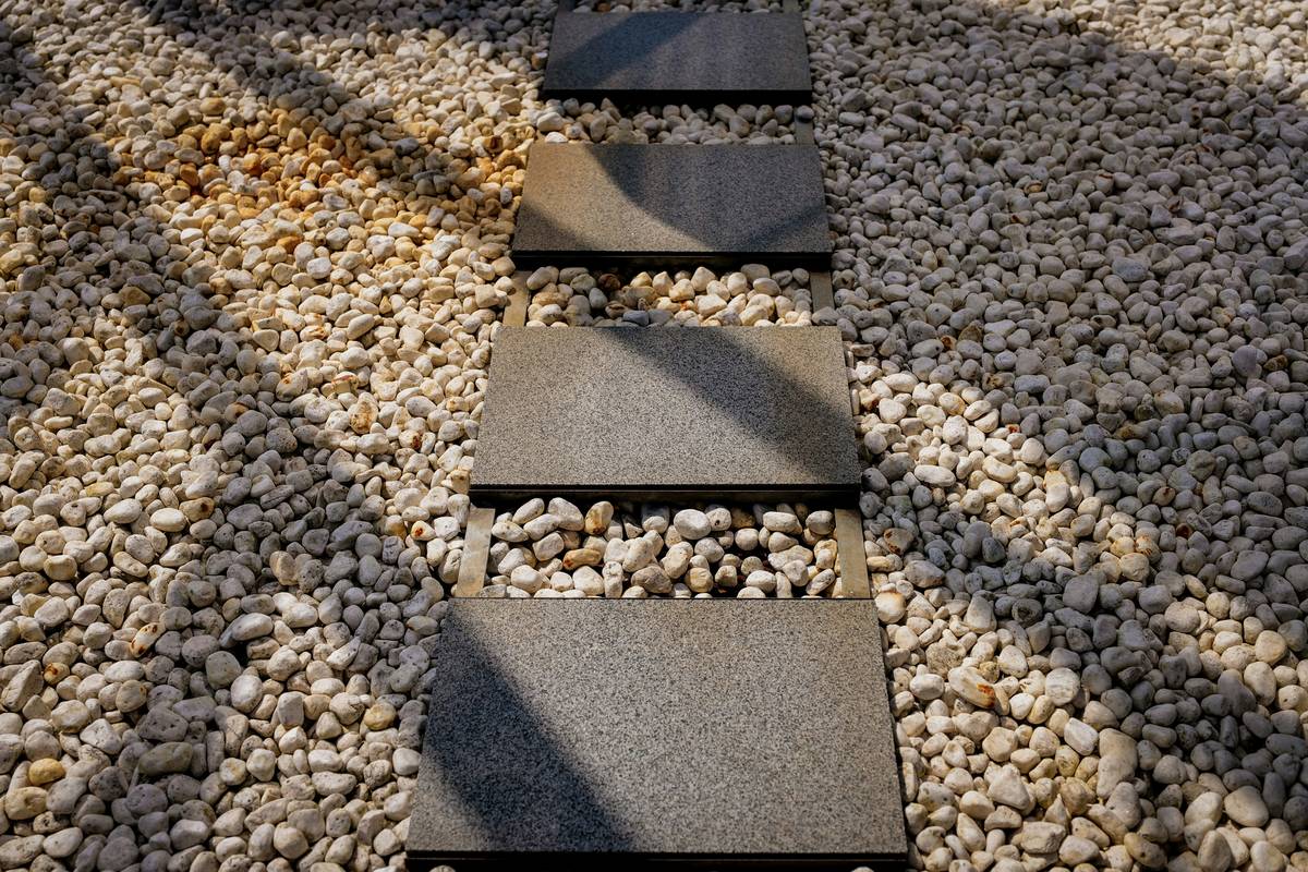 creating a garden path through a desert-friendly backyard with flagstone and gravel